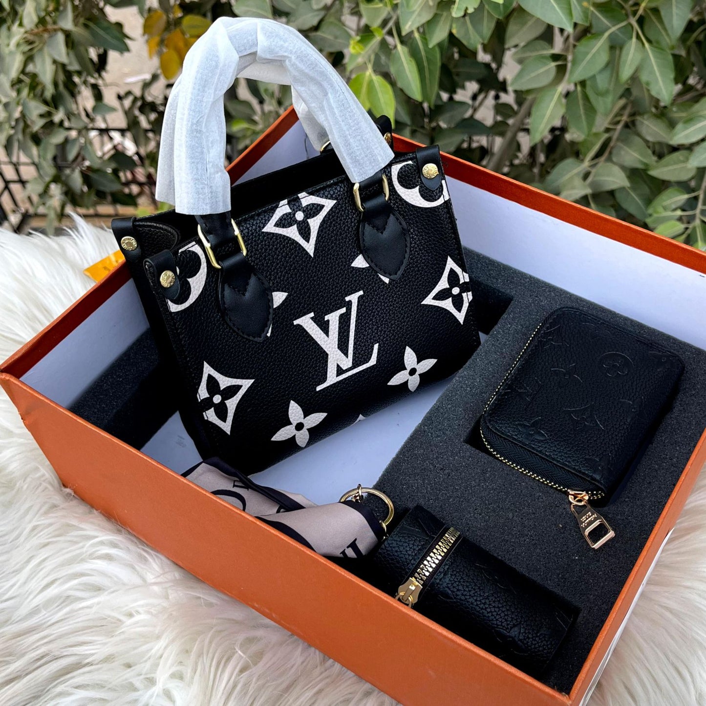 Louis Vuitton OnTheGo tote bag, with a matching wallet and other accessories